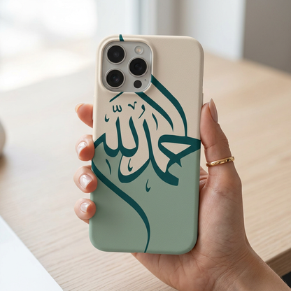 Phone case with Arabic text held by a hand on a light background